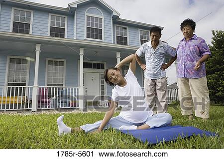 Pregnant woman stretching while her parents stand by and watch View Large Photo Image Stock Image - Pregnant woman stretching while her parents stand by and watch. Fotosearch