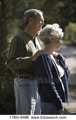 Profile of mature couple standing together View Large Photo Image Stock Photograph - Profile of mature couple standing together. Fotosearch