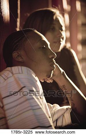 Profile of young couple in dimly lit room View Large Photo Image Stock Photography - Profile of young couple in dimly lit room. Fotosearch