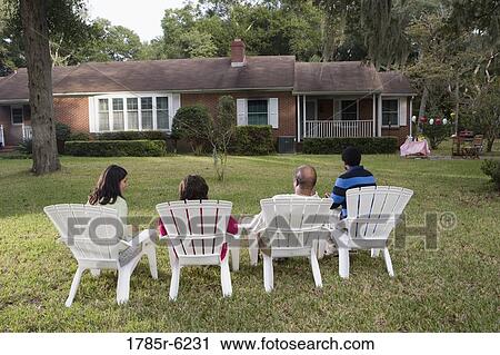Rear view of four people in lawn chairs in backyard View Large Photo Image Stock Image - Rear view of four people in lawn chairs in backyard. Fotosearch