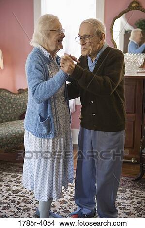 Senior couple dancing in living room View Large Photo Image Picture - Senior couple dancing in living room. Fotosearch