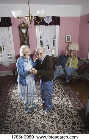 Senior couple dancing in living room View Large Photo Image Stock Image - Senior couple dancing in living room. Fotosearch