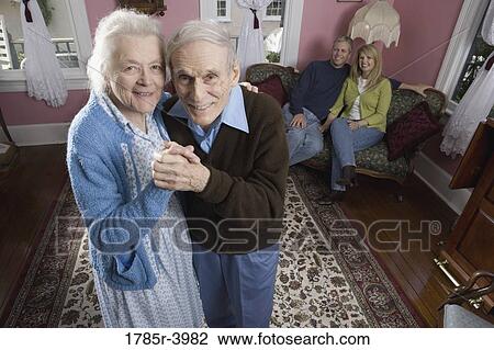 Senior couple dancing in living room View Large Photo Image Stock Image - Senior couple dancing in living room. Fotosearch