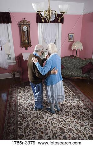 Senior couple dancing in living room View Large Photo Image Stock Photo - Senior couple dancing in living room. Fotosearch