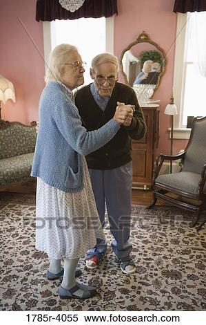 Senior couple dancing in living room View Large Photo Image Stock Photography - Senior couple dancing in living room. Fotosearch