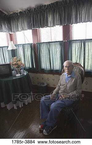Senior man sitting in chair View Large Photo Image Picture - Senior man sitting in chair. Fotosearch