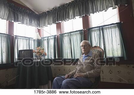 Stock Photograph - Senior man sitting in chair. Fotosearch
