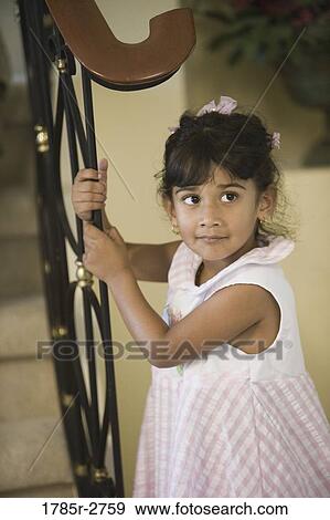 Side view of a girl standing near stairs View Large Photo Image Stock Photo - Side view of a girl standing near stairs. Fotosearch
