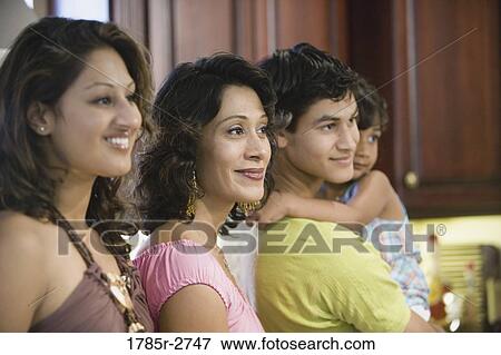 Side view of family in the kitchen View Large Photo Image Stock Photo - Side view of family in the kitchen. Fotosearch