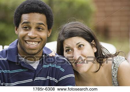 Stock Photo - Smiling young inter-racial couple. Fotosearch