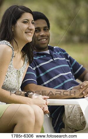 Smiling young inter-racial couple View Large Photo Image Stock Photograph - Smiling young inter-racial couple. Fotosearch