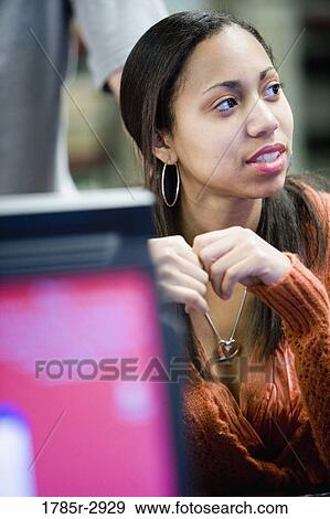 Student sitting in front of computer monitor View Large Photo Image Stock Photo - Student sitting in front of computer monitor. Fotosearch