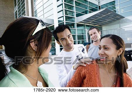 Students hanging out and socializing in front of a building View Large Photo Image Stock Image - Students hanging out and socializing in front of a building. Fotosearch