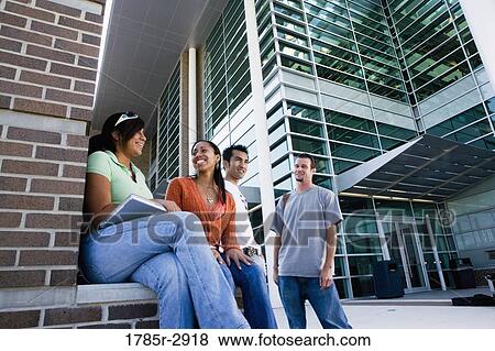 Students hanging out and socializing in front of a building View Large Photo Image Stock Photo - Students hanging out and socializing in front of a building. Fotosearch