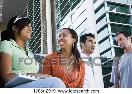 Students hanging out and socializing in front of a building View Large Photo Image Stock Photo - Students hanging out and socializing in front of a building. Fotosearch
