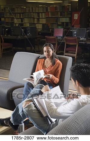 Students in library sitting on chairs studying View Large Photo Image Stock Photo - Students in library sitting on chairs studying. Fotosearch