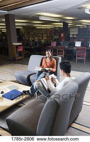 Students in library sitting on chairs studying View Large Photo Image Stock Photograph - Students in library sitting on chairs studying. Fotosearch