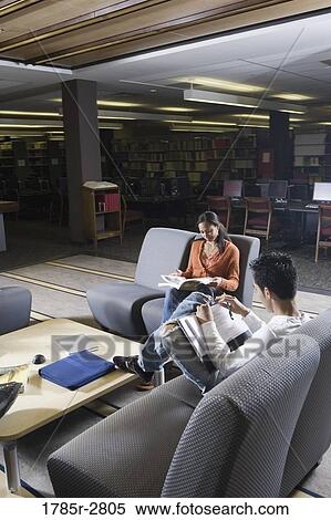 Students in library sitting on chairs studying View Large Photo Image Stock Photography - Students in library sitting on chairs studying. Fotosearch