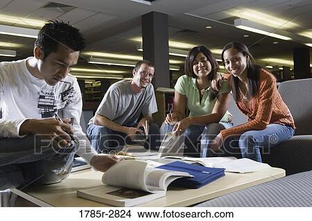Picture - Students in library sitting on sofas studying. Fotosearch