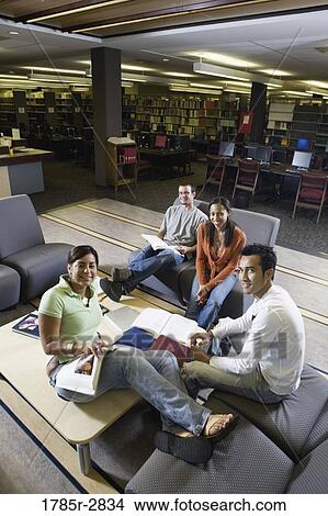 Students in library sitting on sofas studying View Large Photo Image Picture - Students in library sitting on sofas studying. Fotosearch