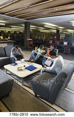Students in library sitting on sofas studying View Large Photo Image Stock Image - Students in library sitting on sofas studying. Fotosearch