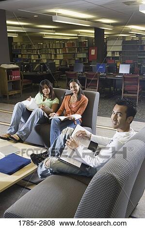 Students in library sitting on sofas studying View Large Photo Image Stock Photo - Students in library sitting on sofas studying. Fotosearch