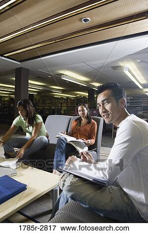 Stock Photo - Students in library sitting on sofas studying. Fotosearch