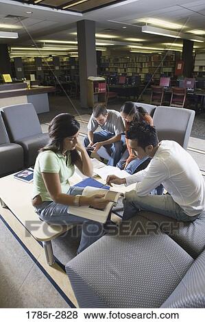 Stock Photo - Students in library sitting on sofas studying. Fotosearch