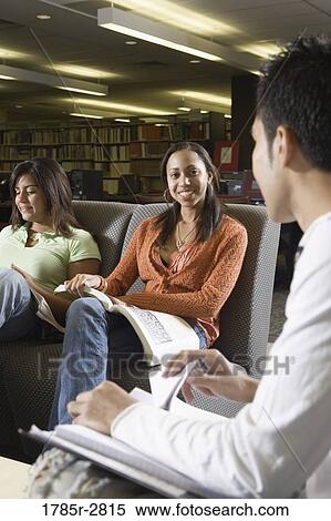 Students in library sitting on sofas studying View Large Photo Image Stock Photography - Students in library sitting on sofas studying. Fotosearch