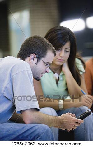 Students looking at a calculator View Large Photo Image Stock Image - Students looking at a calculator. Fotosearch