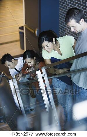 Students looking downwards from stairway View Large Photo Image Stock Photo - Students looking downwards from stairway. Fotosearch