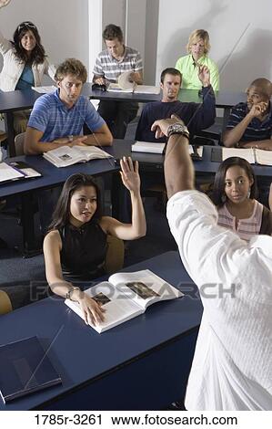 Students raising hands in the classroom View Large Photo Image Stock Image - Students raising hands in the classroom. Fotosearch