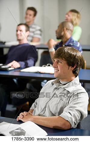 Stock Image - Students sitting in the classroom. Fotosearch