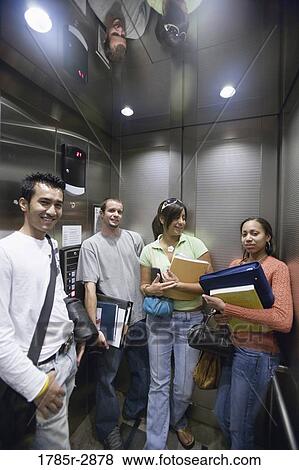 Stock Photo - Students standing in an elevator. Fotosearch