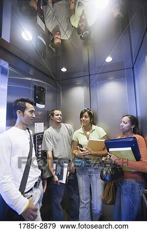 Stock Photo - Students standing in an elevator. Fotosearch