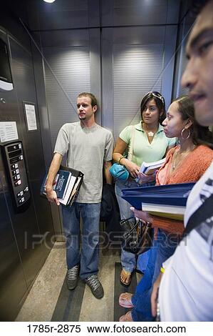 Students standing in an elevator View Large Photo Image Stock Photography - Students standing in an elevator. Fotosearch