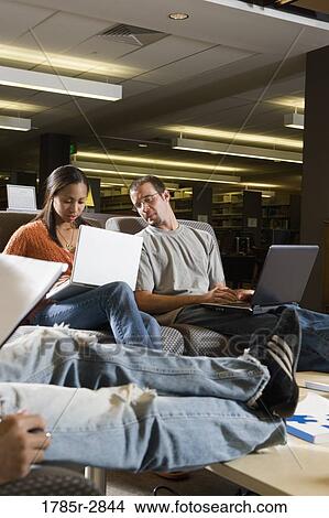 Students with laptop computers in library sitting on sofas studying View Large Photo Image Picture - Students with laptop computers in library sitting on sofas studying. Fotosearch