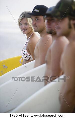 Surfer dudes and girl posing on beach with surfboards View Large Photo Image Stock Image - Surfer dudes and girl posing on beach with surfboards. Fotosearch