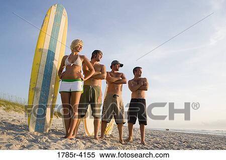 Surfer dudes and girl posing on beach surfboards View Large Photo Image Stock Photography - Surfer dudes and girl posing on beach surfboards. Fotosearch