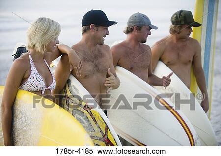 Surfer dudes and girl posing on beach with surfboards View Large Photo Image Stock Photography - Surfer dudes and girl posing on beach with surfboards. Fotosearch