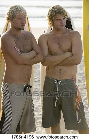 Surfer dudes posing on beach with surfboards View Large Photo Image Stock Photograph - Surfer dudes posing on beach with surfboards. Fotosearch
