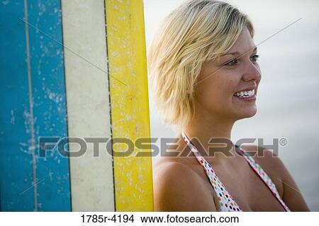 Surfer girl with a surfboard View Large Photo Image Picture - Surfer girl with a surfboard. Fotosearch