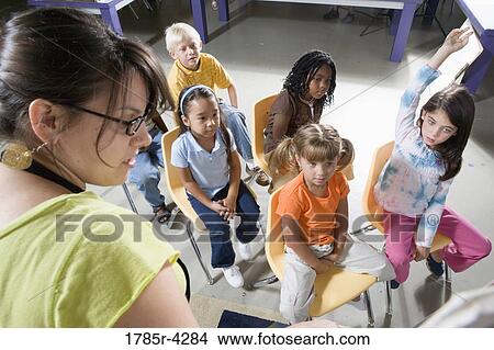 Teacher in classroom teaching young children View Large Photo Image Picture - Teacher in classroom teaching young children. Fotosearch