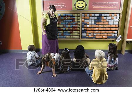 Teacher shows children an interactive art display View Large Photo Image Picture - Teacher shows children an interactive art display. Fotosearch