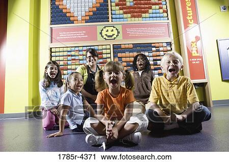 Teacher sitting with young children View Large Photo Image Stock Image - Teacher sitting with young children. Fotosearch
