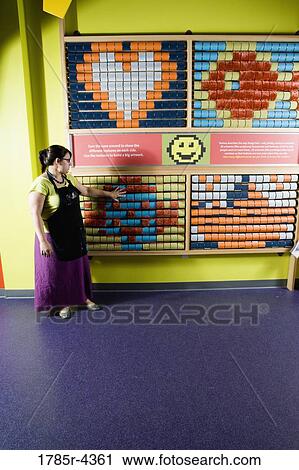Teacher standing in front of an interactive art display View Large Photo Image Stock Image - Teacher standing in front of an interactive art display. Fotosearch