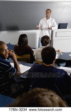 Teacher teaching students in the classroom View Large Photo Image Picture - Teacher teaching students in the classroom. Fotosearch