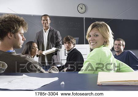 Teacher teaching students in the classroom View Large Photo Image Picture - Teacher teaching students in the classroom. Fotosearch