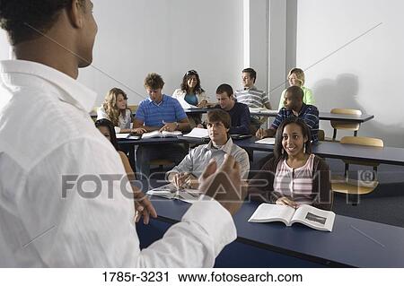Stock Image - Teacher teaching students in the classroom. Fotosearch