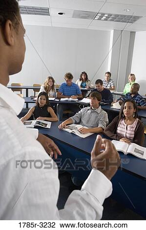 Stock Image - Teacher teaching students in the classroom. Fotosearch